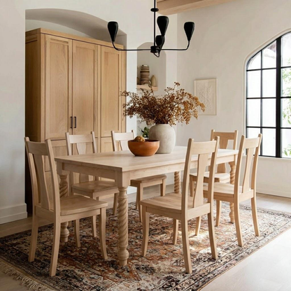 Dining room with wooden table and chairs, large window, and decorative elements.