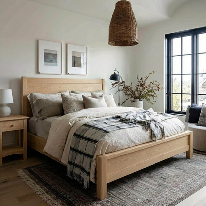 Modern bedroom with wooden bed, plaid blanket, and large windows.