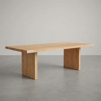 Wooden dining table on a gray floor with a neutral background