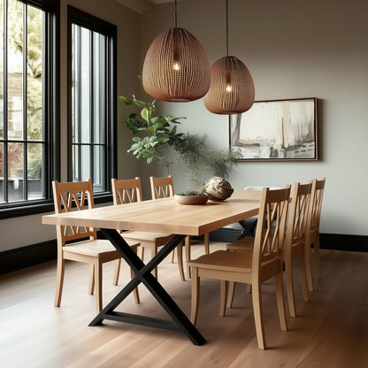 Dining room with wooden table and chairs, modern pendant lights, and a painting on the wall.