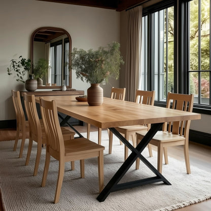Dining room with wooden table and chairs, large mirror, and plants.
