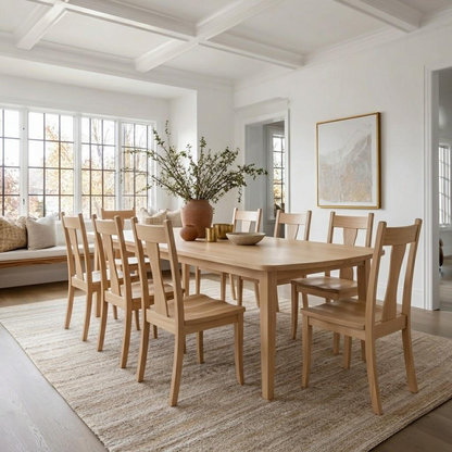Dining room with wooden table and chairs in a bright room.