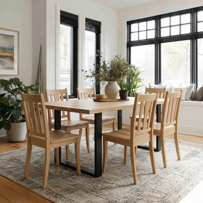 Dining room with wooden table and chairs in a well-lit room.