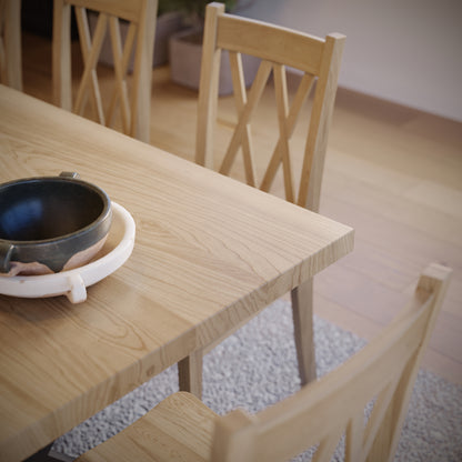 close up image of a maple dining table with black metal legs