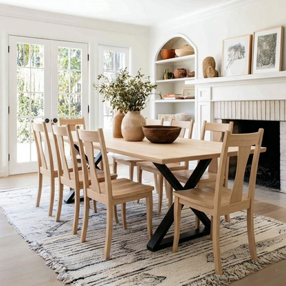 Dining room with wooden table and chairs, fireplace, and decorative items.
