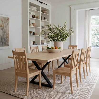 Dining room with wooden table and chairs, white bookshelf, and large window.