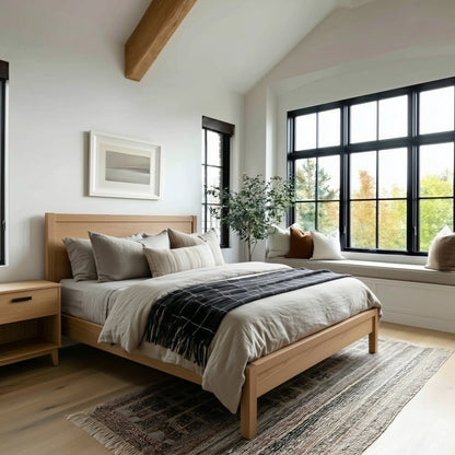 Modern bedroom with wooden bed, large windows, and a plant.