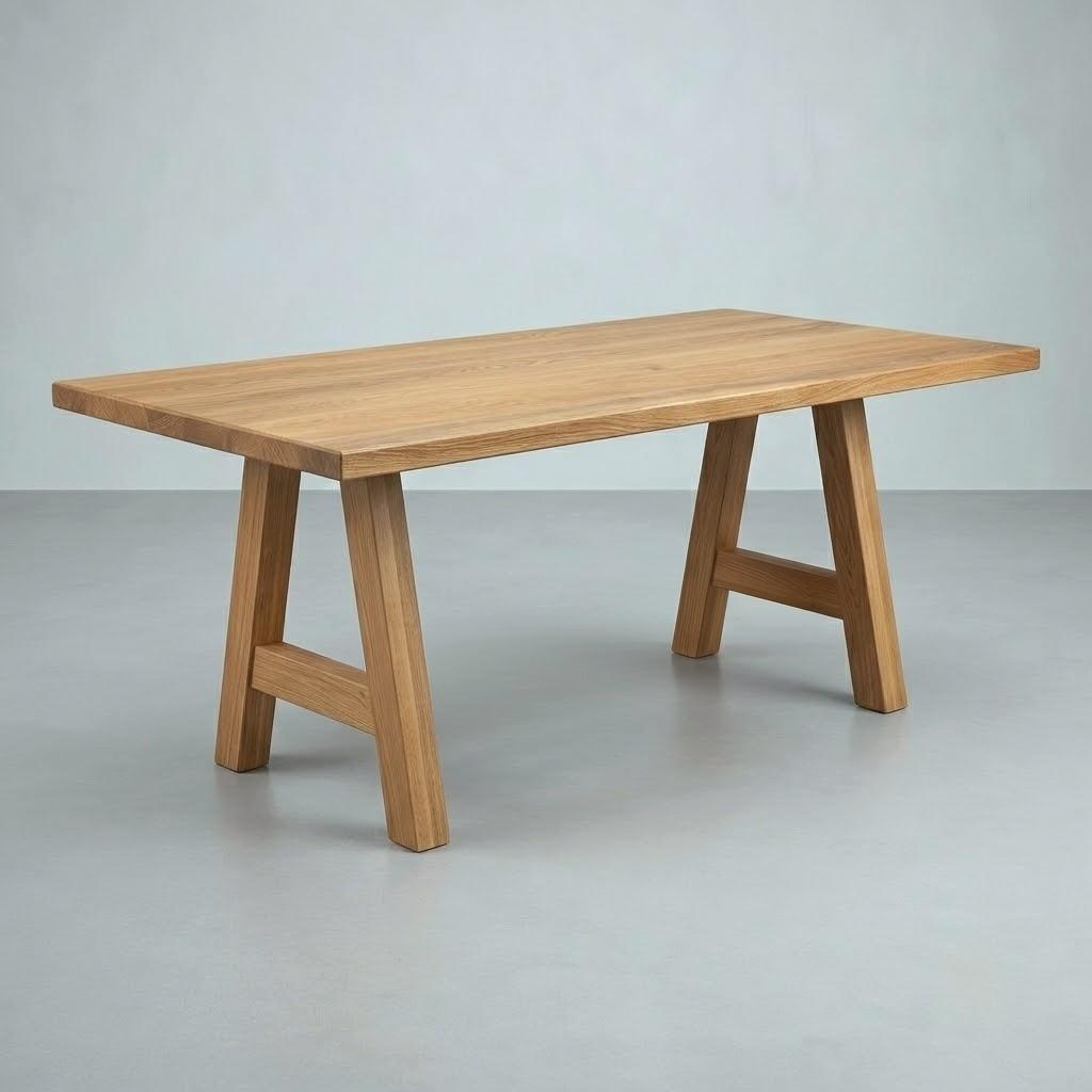 A rectangular wooden dining table with a natural oak finish, featuring A-frame legs and a simple rectangular top, set against a neutral gray studio background.