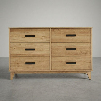 Wooden dresser with four drawers on a gray background