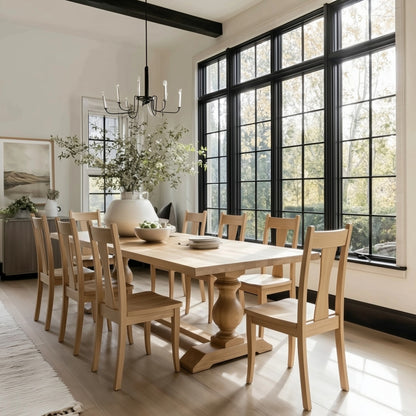 Dining room with wooden table and chairs near large windows