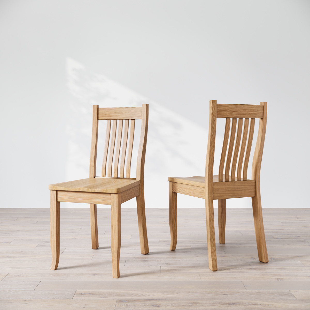 Two Oak Ensworth dining chairs, one facing forward and the other showing the side profile.
