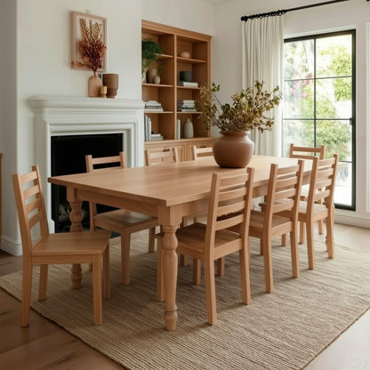 Dining room with wooden table and chairs, fireplace, and large window.
