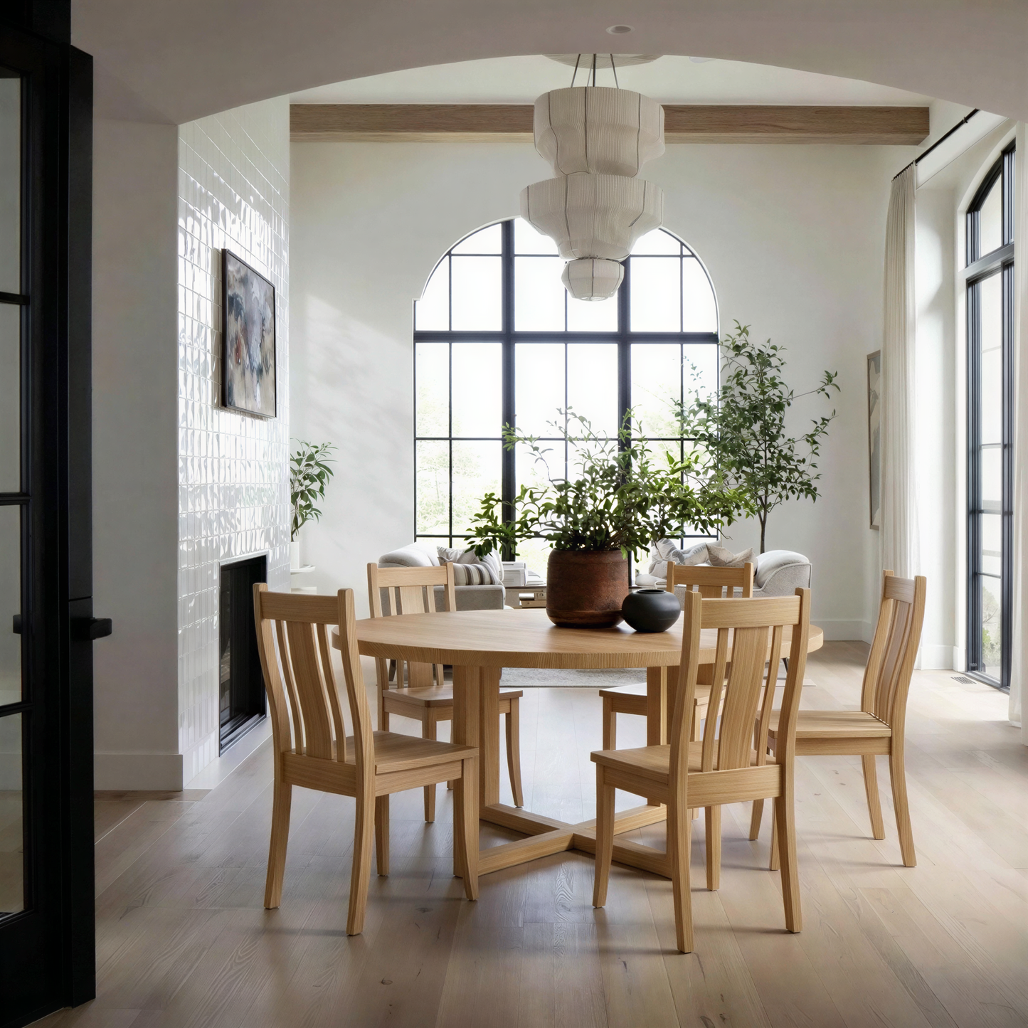 Dining room with wooden table and chairs, modern light fixture, and large plant on the table
