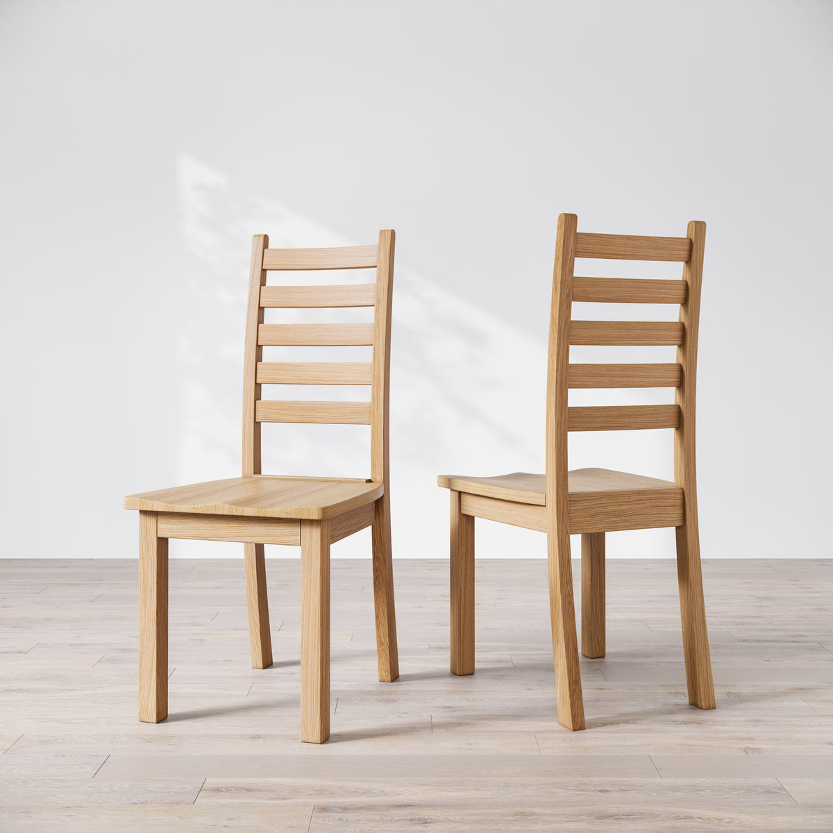 Two oak wood Heisly dining chairs with a commercial grade finish, displayed against a white background.