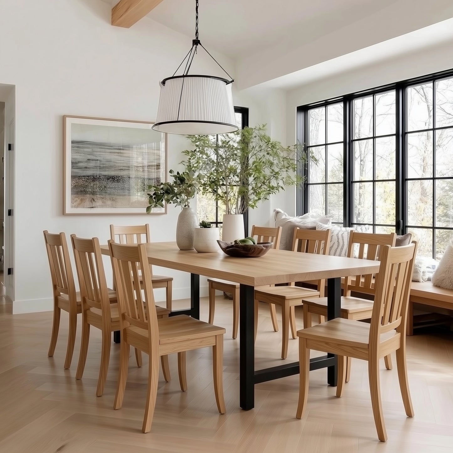 Dining room with wooden table and chairs, large windows, and decorative elements.