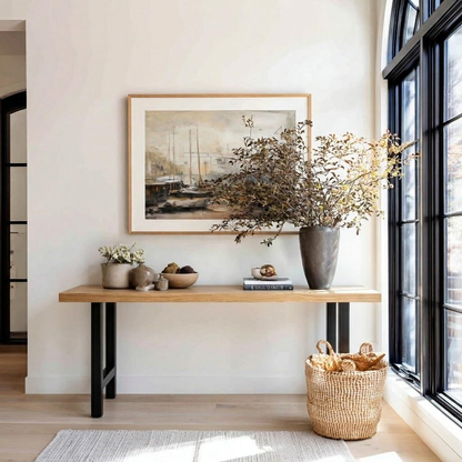 Nook with a wooden table, decorative items, and a large window.