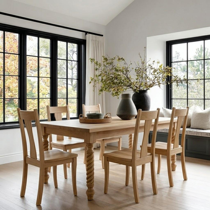 Dining room with wooden table and chairs, large windows, and decorative elements.