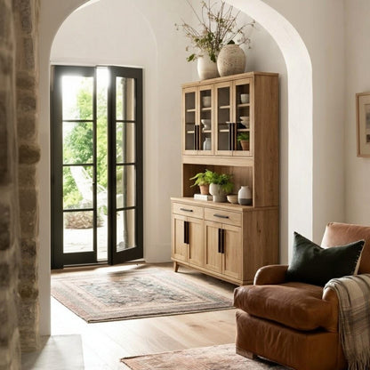 Wooden cabinet with glass doors in a room with a plant and rug.