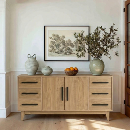 Wooden sideboard with decorative items in a room with a painting on the wall.