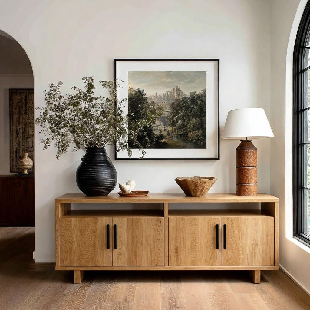 Wooden sideboard with decorative items in a room with a painting on the wall.