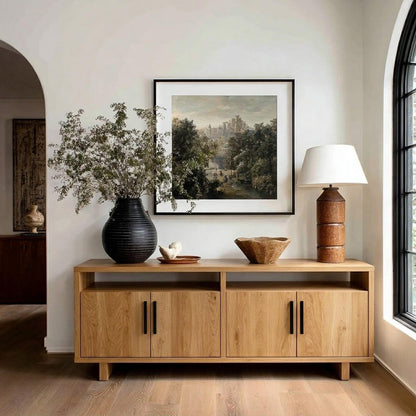 Wooden sideboard with decorative items in a room with a painting on the wall.