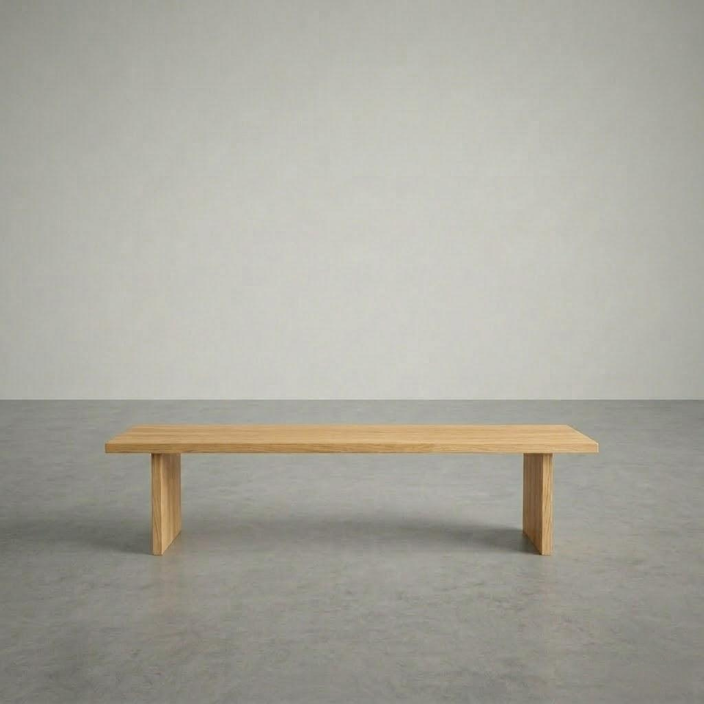 Wooden bench on a gray floor with a plain gray wall background