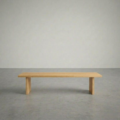 Wooden bench on a gray floor with a plain gray wall background