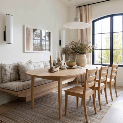 Dining room with wooden table and chairs, large window, and decorative elements.