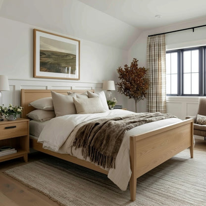 Bedroom with wooden bed, pillows, and a large window.