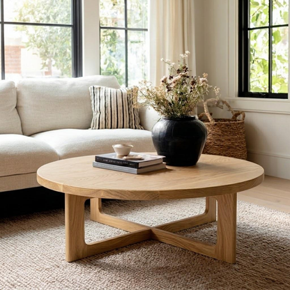Wooden coffee table with a vase and books in a living room setting