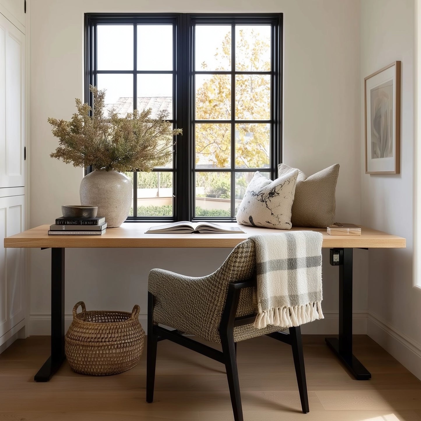 Home office with wooden desk, chair, and decorative elements.