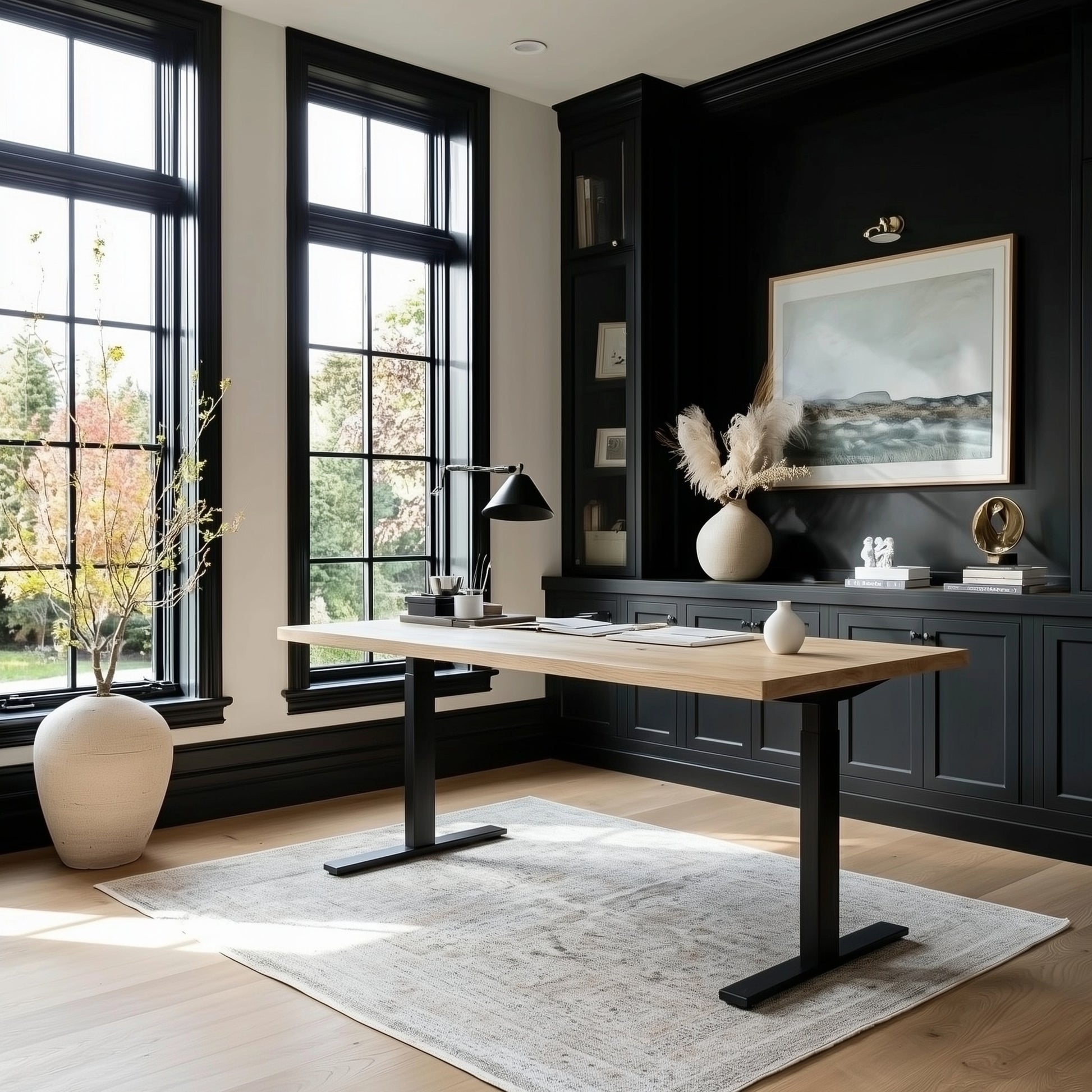Modern home office with a wooden desk, black lamp, and decorative elements.