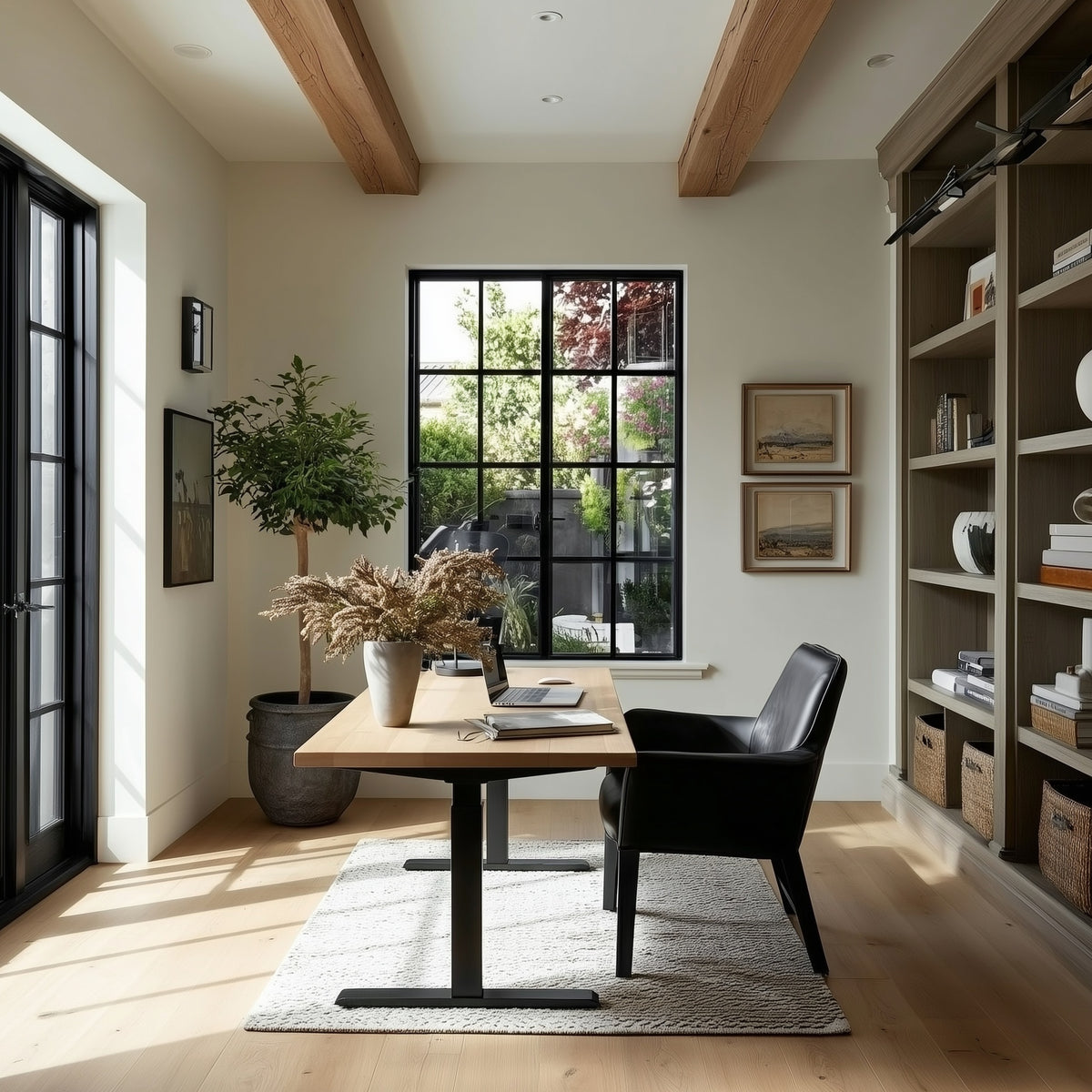 Modern home office with oak standing desk, beams, black chair, and bookshelf.