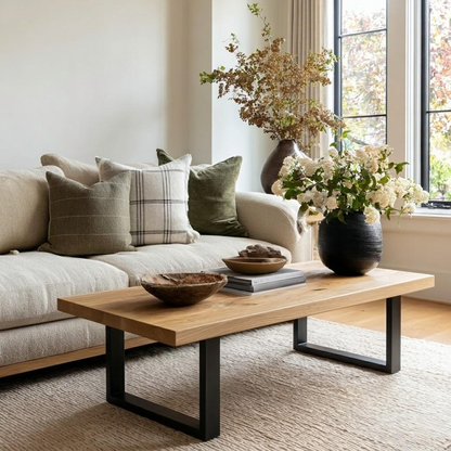 Living room with a beige sofa, wooden coffee table, and decorative elements.