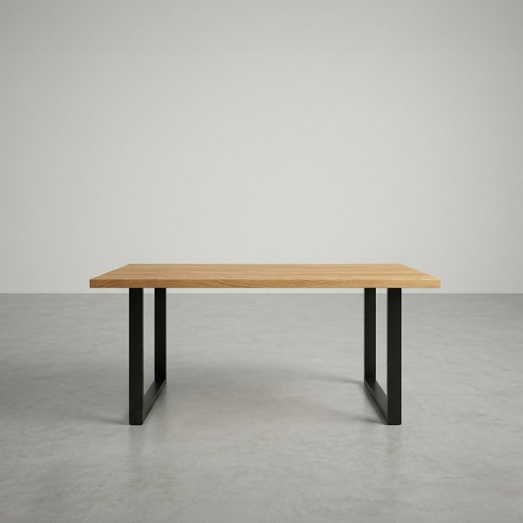 wooden desk with black metal legs in a large empty room