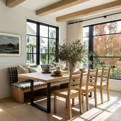 Modern dining room with wooden table, chairs, and a bench with plaid cushions.