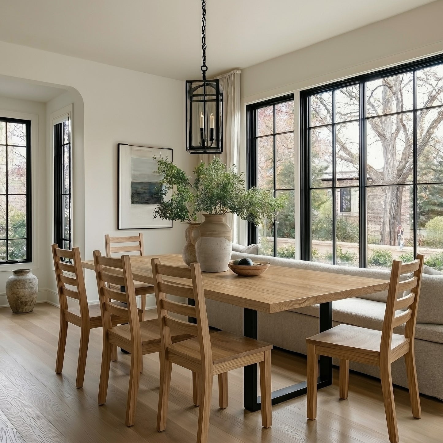 Dining room with wooden table and chairs near large windows