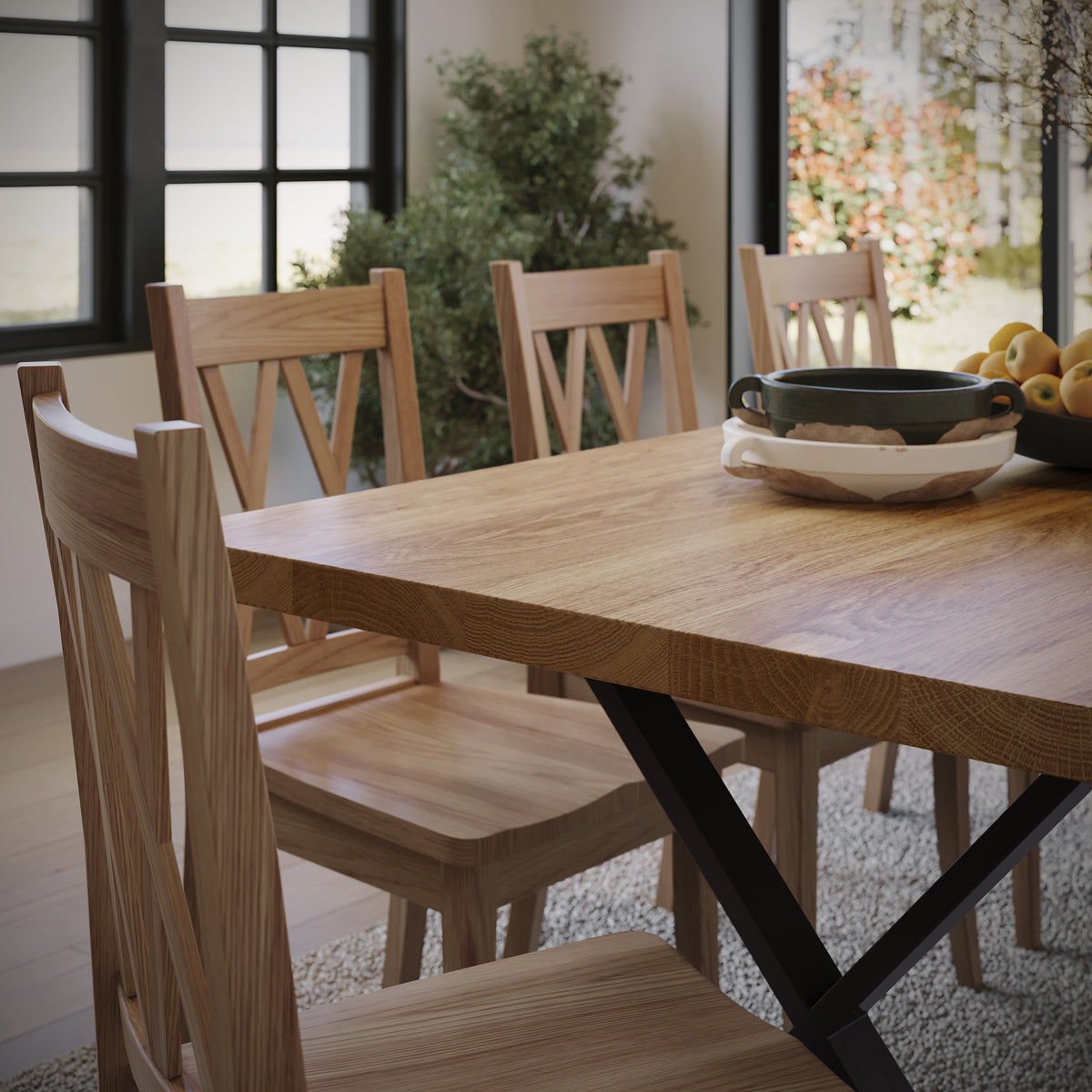 close up image of an oak dining table with black metal legs