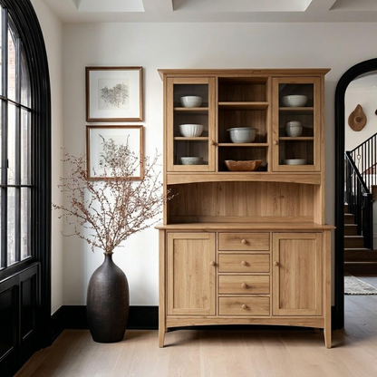 Wooden hutch with shelves and drawers in a room with a window and staircase.