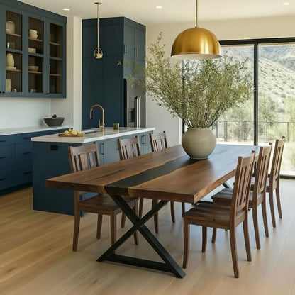 Modern kitchen with wooden dining table and chairs, gold pendant light, and large windows.
