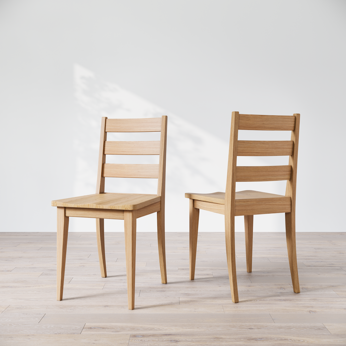 Two wooden dining chairs featuring a simple, solid backrest and seat design on a light background.