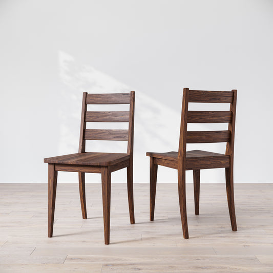 Two wooden dining chairs with a dark finish, featuring a simple, solid backrest and seat design on a light background.