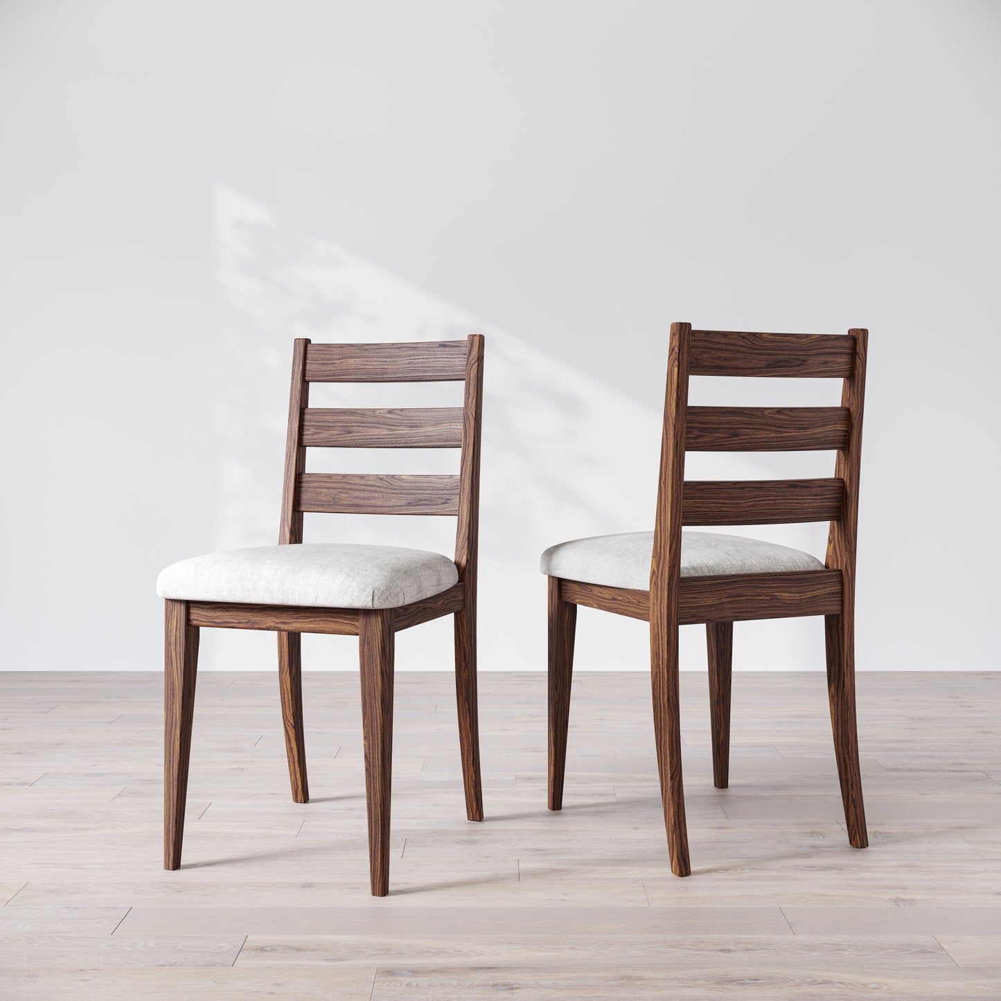 Two wooden dining chairs with a dark finish and upholstered seats, featuring a simple, solid backrest on a light background.