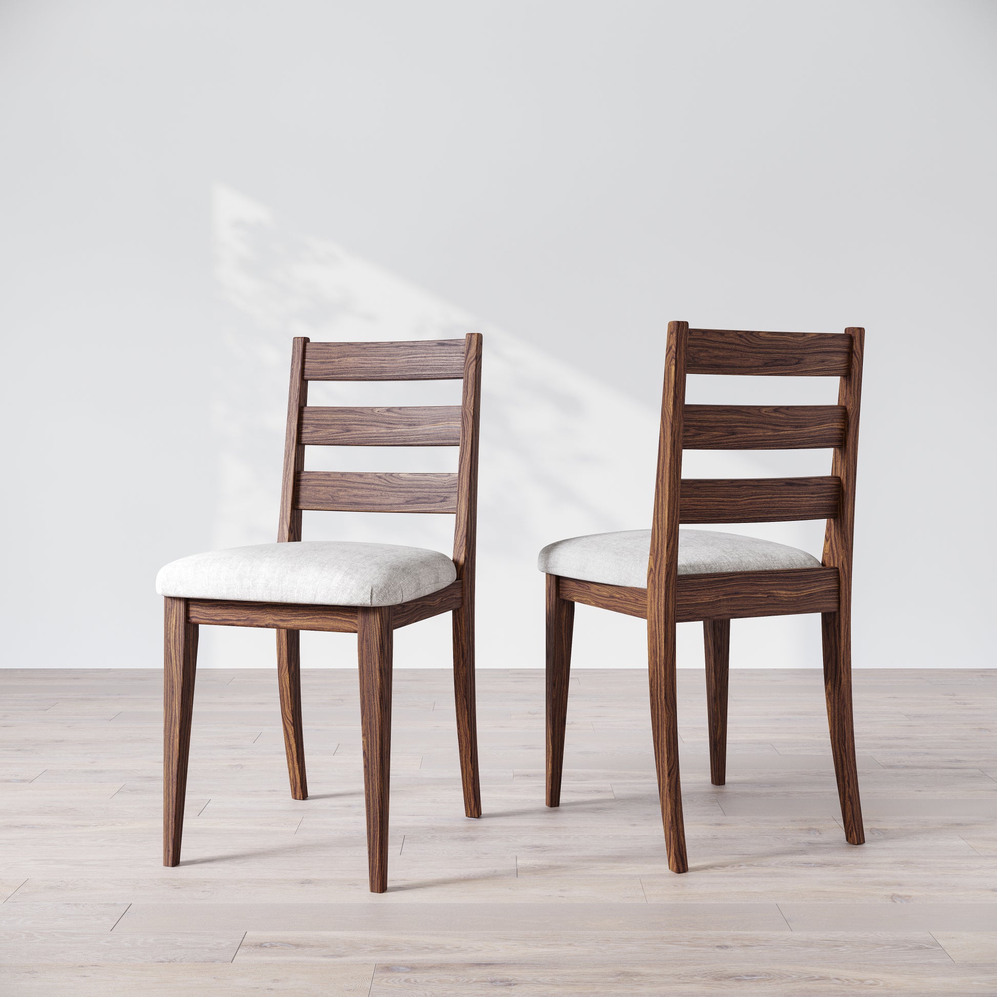 Two wooden dining chairs with a dark finish and upholstered seats, featuring a simple, solid backrest on a light background.