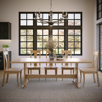 Dining room with wooden table and chairs under a chandelier.