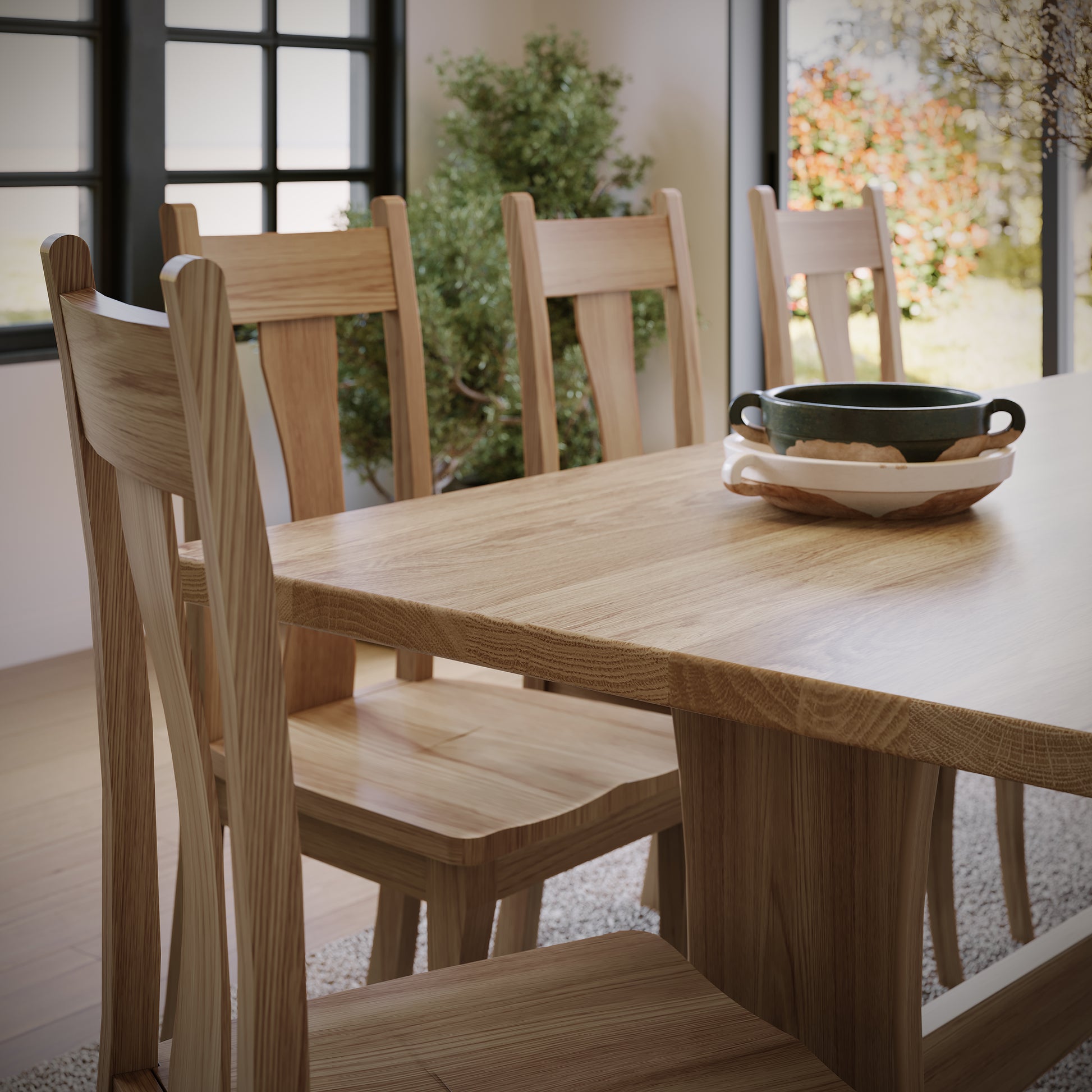 Wooden dining table with chairs in a bright room.