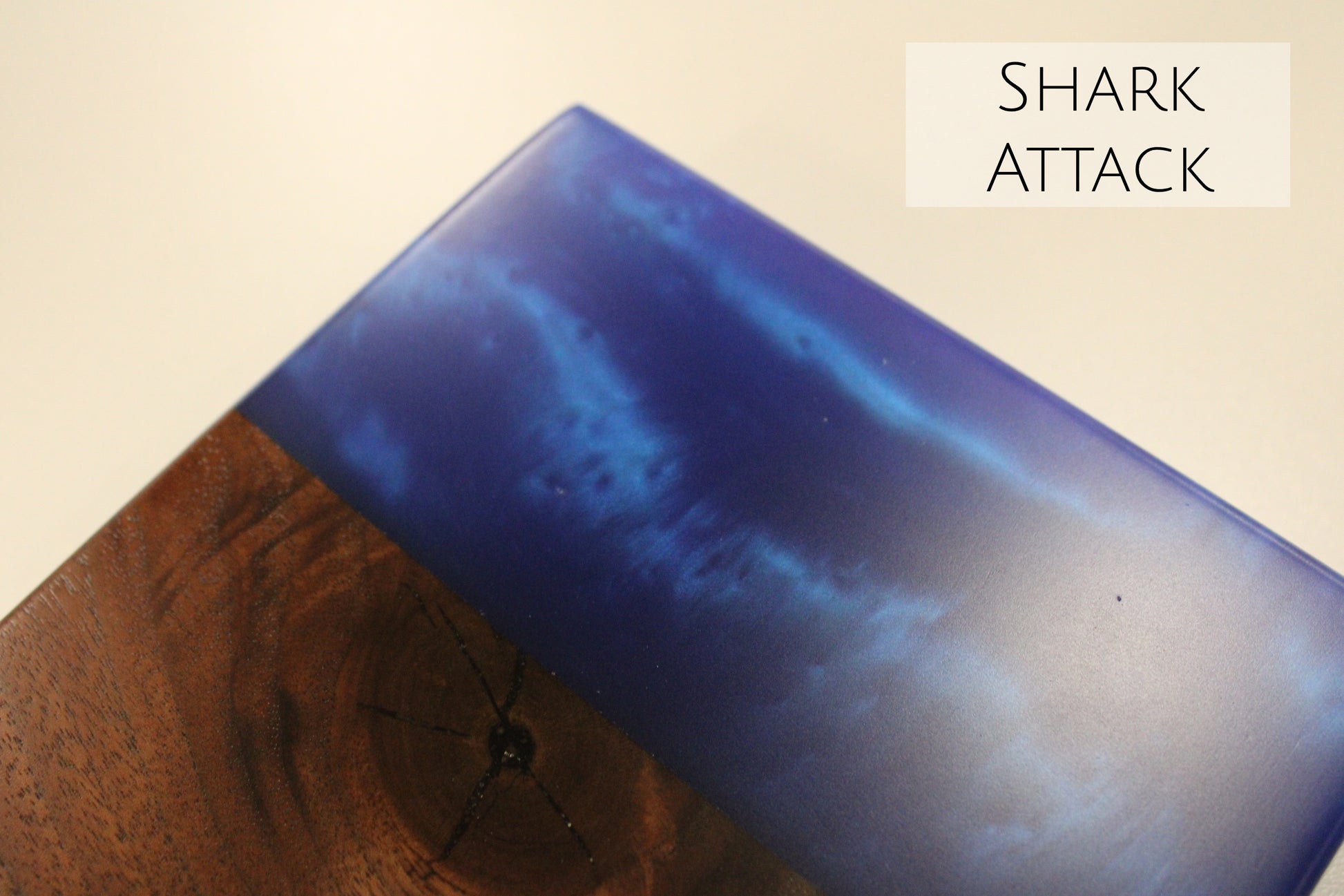 A close up of a walnut and blue epoxy sample