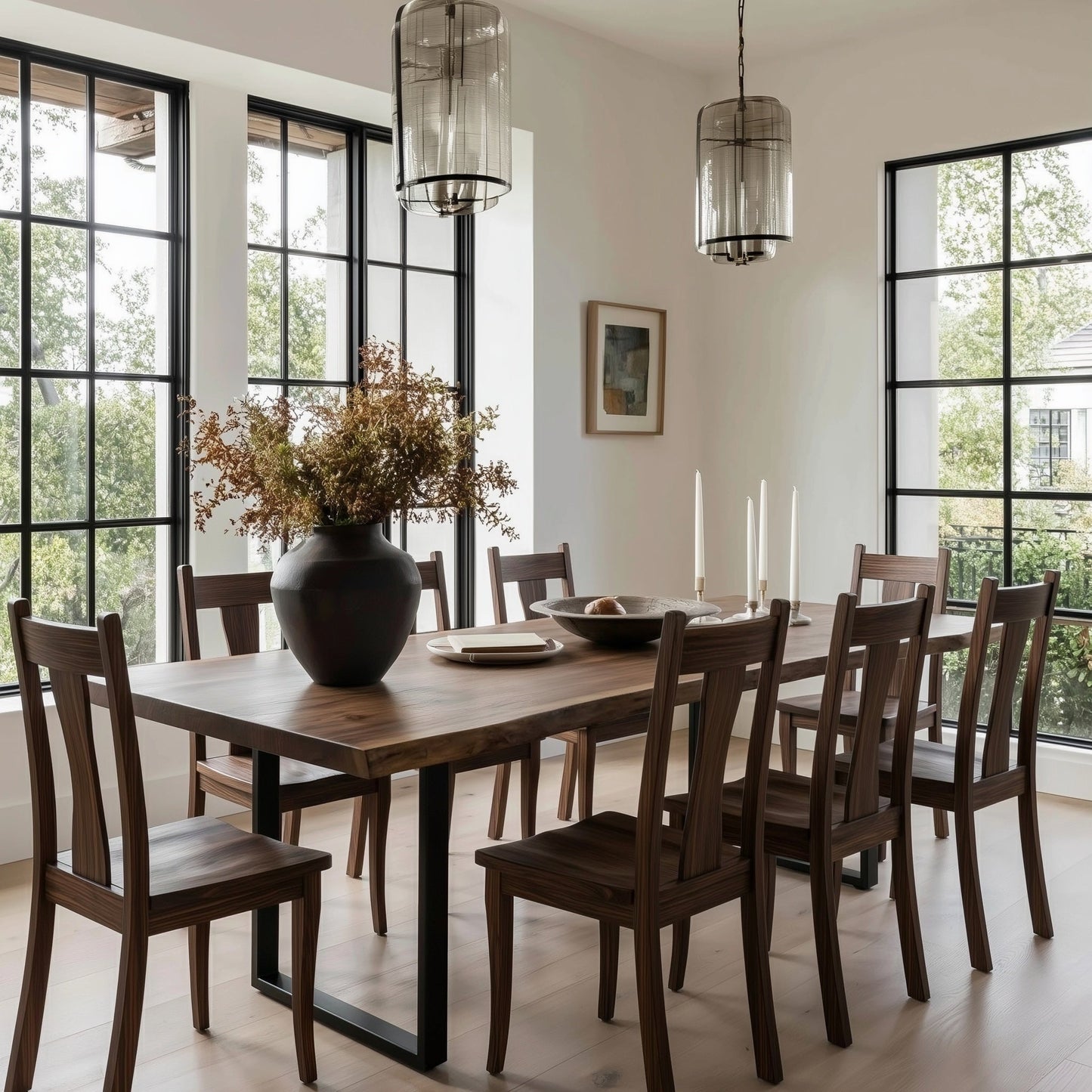 Dining room with wooden table and chairs, large windows, and decorative elements.