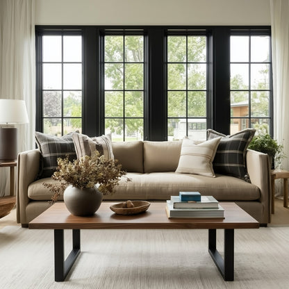Living room with beige sofa, wooden coffee table, and large windows.