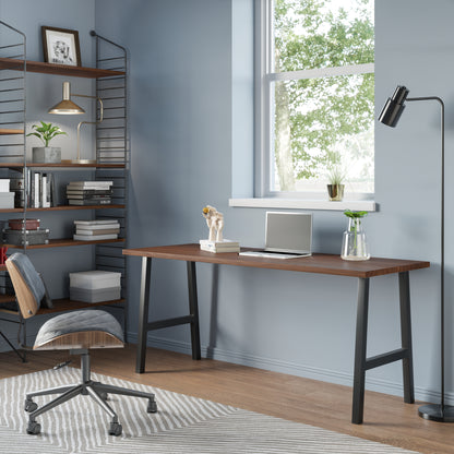 A desk made of walnut with metal legs in a home office with shelving and books